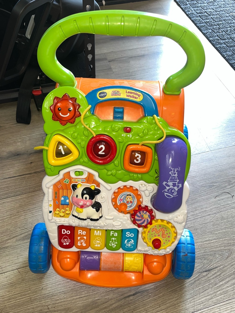 VTech Sit-To-Stand Learning Walker in orange.